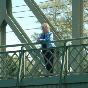 Actor Karolyn Grimes who played Zuzu stands on the bridge.