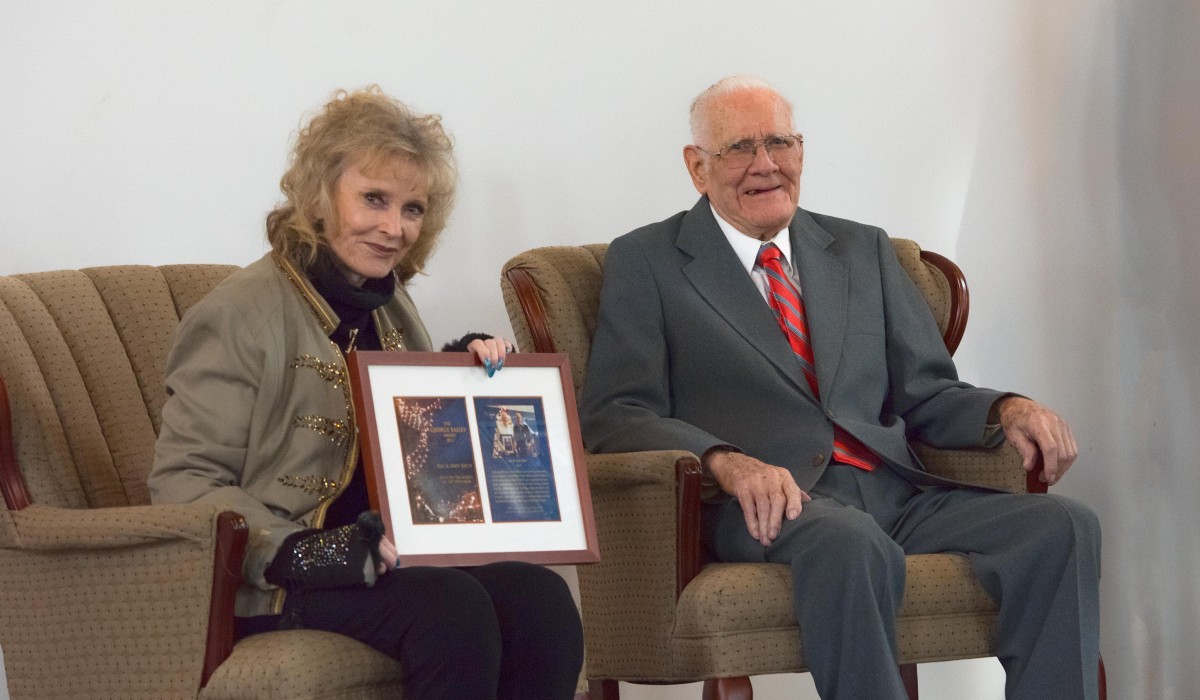 Karolyn Grimes presents the 14th Annual George Bailey award to Reg Batty and his twin brother Andy (who passed away in August, 2017).  Reg passed away less than three weeks after receiving the Award.  Photo by Henry Law