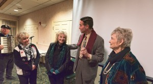 Actor Brian Rohan (Jimmy Stewart/George Bailey) sings "Easy to Love" to Carol Coombs, Karolyn Grimes and Jeanine Roose at the Final Scene Dinner on Sunday night.  Ron Owens accompanied him on the accordion.  Photo by Henry Law