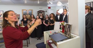Anna Luisi-Ellis directs the Mynderse Academy Chamber Singers prior to the Press Conference at The Seneca Falls It's a Wonderful Life Museum.  Photo by Henry Law 