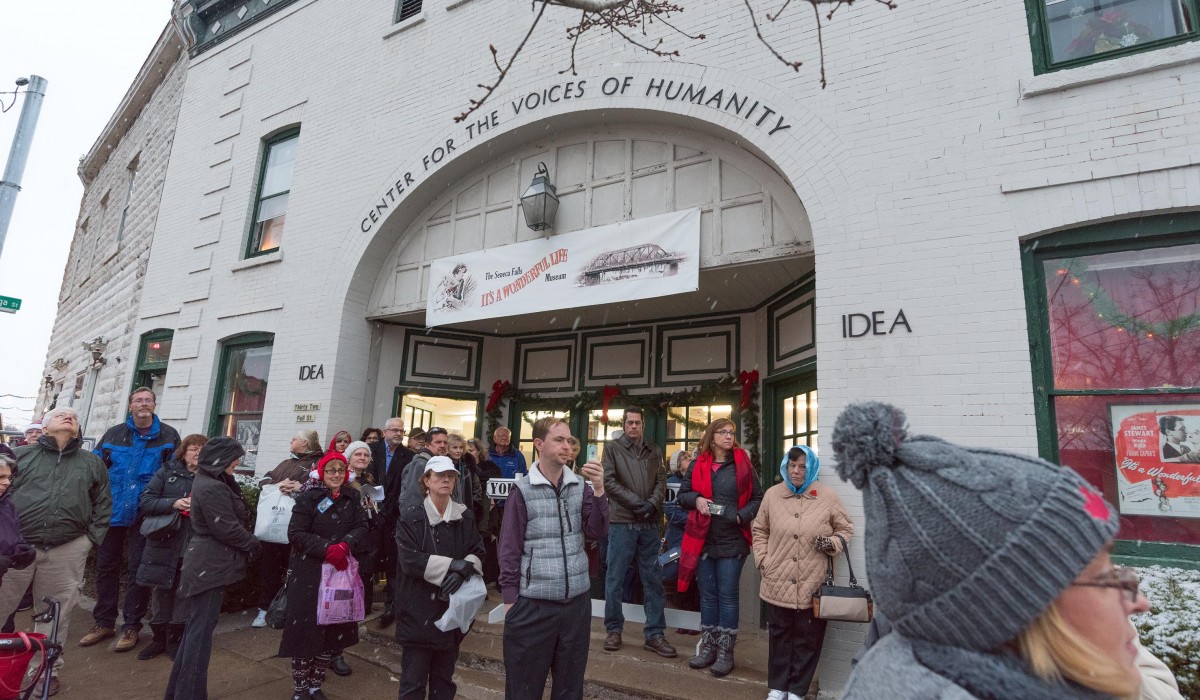 Joining together to listen to the ringing of the Bells of the Real Bedford Falls during the It's a Wonderful Life Festival.  Photo by Henry Law