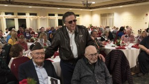 World War II Veterans Ed Chase and John Robbins are honored by Jimmy Hawkins (Tommy Bailey), other cast members and fans from around the country who attended the Sunday night dinner "Welcome Home, Harry Bailey -- Celebrating the Final Scene of 'It's a Wonderful Life.'" Photo by Henry Law